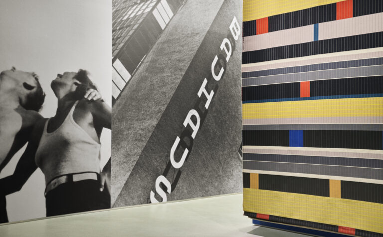 Designtex NeoCon showroom displaying the Bauhaus Project with archival photography used as a wallcovering, and a modern recreation of a Bauhaus textile.