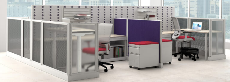 A grey office cubicle containing a divider in a blue fabric, and a chair and ped covered in a red fabric.