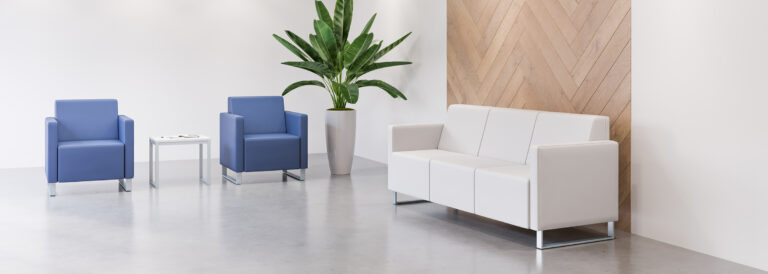 Two stance chairs and a lounge in a reception setting.