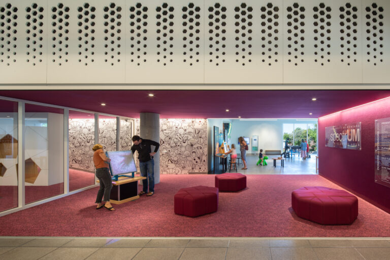 image of a library with berry colored upholstery and carpet
